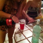 Sara pouring me a Rum and Coke and Malin making food in playa