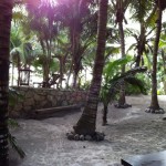 the courtyard at Casa De Las Olas in Tulum with white sands and sunshine